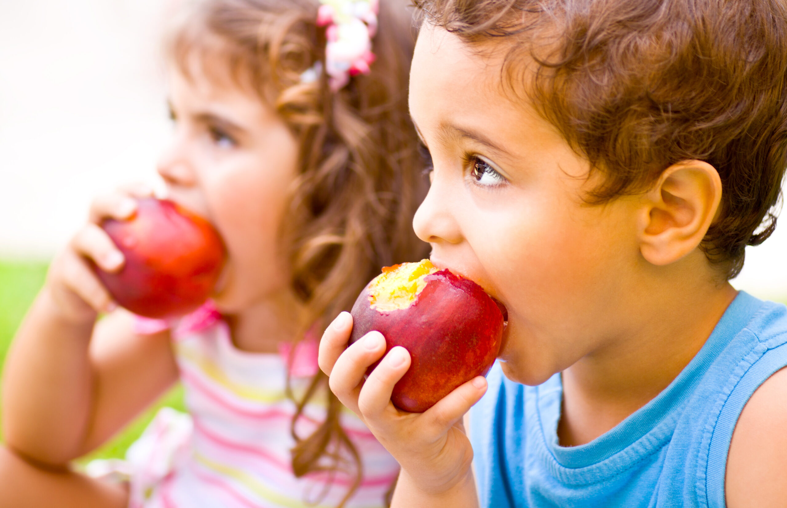 Happy children eating apple